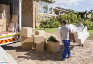 Déménageurs transportant un canapé d'une fourgonnette à une maison